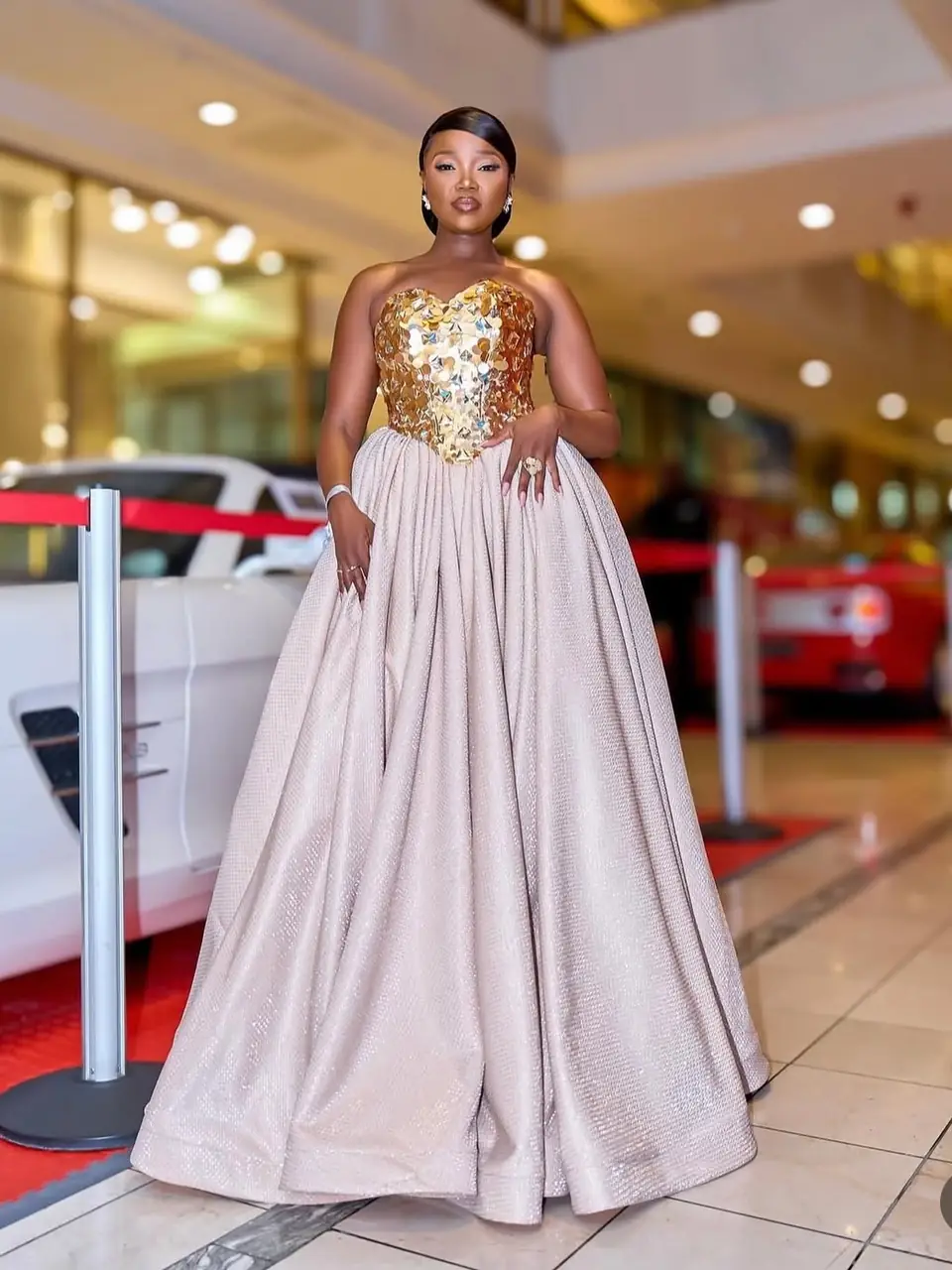 Strapless ball gown with a gold paillette bodice and a full champagne skirt